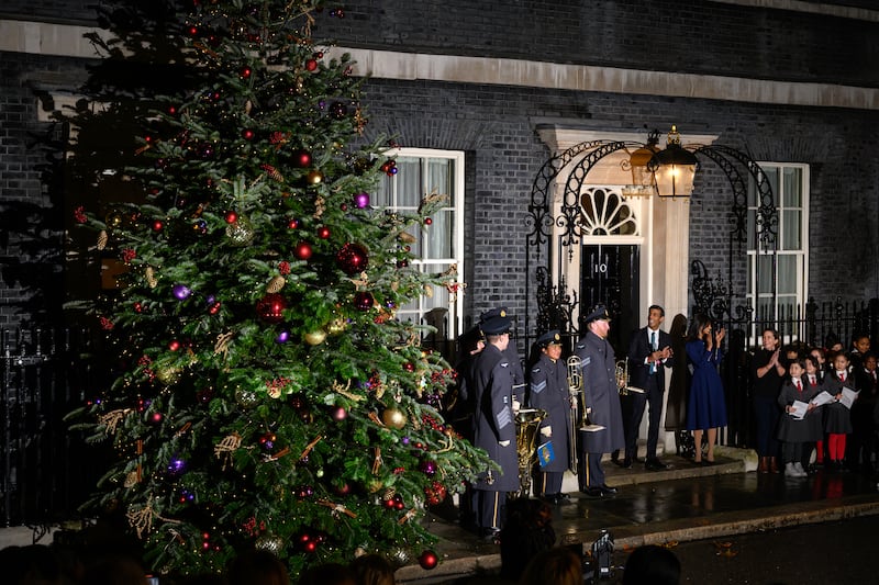Mr Sunak and his wife outside No 10 as the Christmas lights are turned on. Getty Images