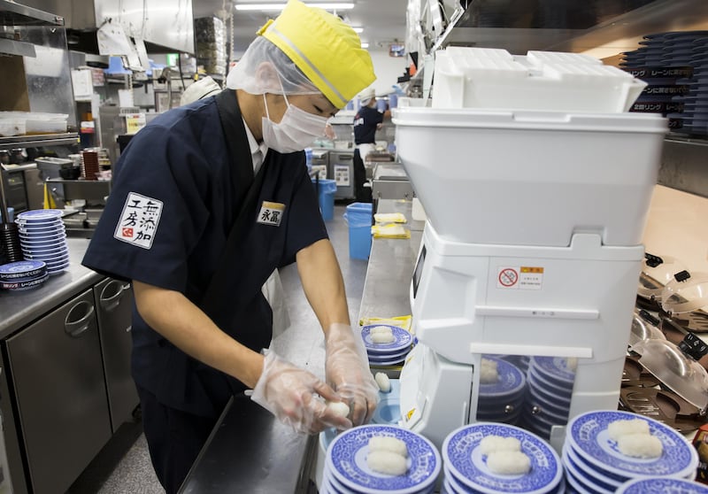 A chef prepares sushi using a Suzumo Machinery Co. sushi-making machine inside a Kura Corp. sushi restaurant in Kaizuka, Osaka, Japan, on Thursday, Aug. 17, 2017. Suzumo Machinery's robots are used by about 70,000 customers around the world, ranging from sushi chains to factories, and account for about 70 percent of the market for the equipment at restaurants, according to Suzumo���s estimates. Photographer: Tomohiro Ohsumi/Bloomberg