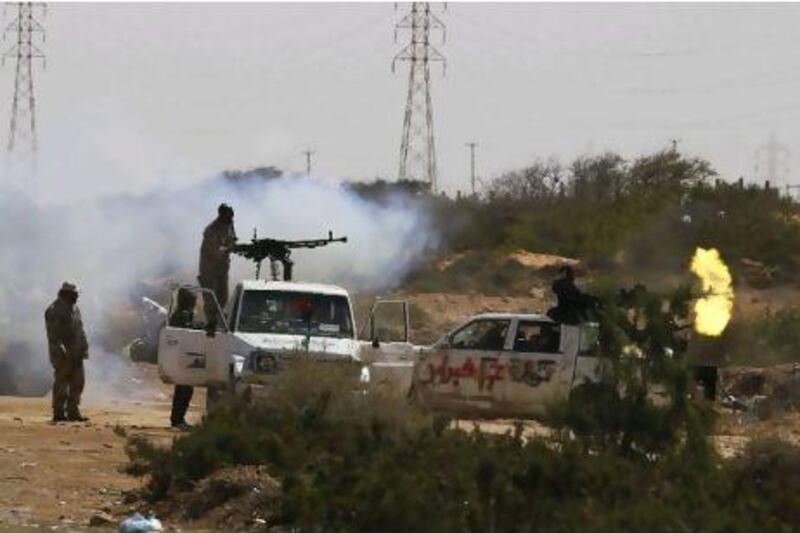 Rebels fire in pursuit of government troops east of Sirte in eastern Libya yesterday.