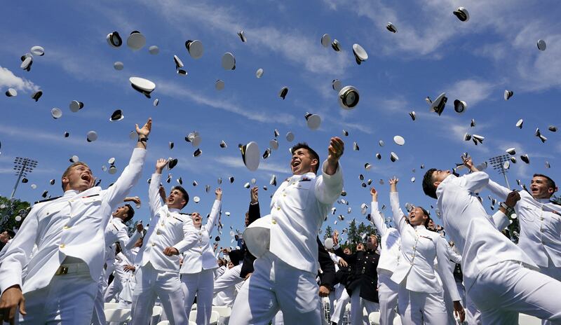 Graduates toss their caps in the air at the US Naval Academy graduation and commissioning ceremony in Annapolis, Maryland. Reuters