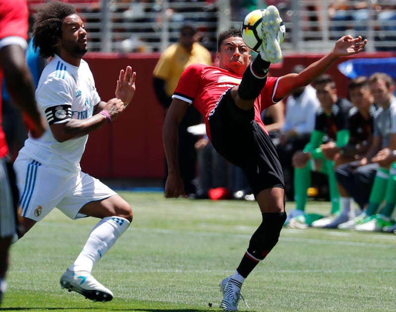 Manchester United midfielder Jesse Lingard, right, in action against Real Madrid defender Marcelo. John G Mabanglo / EPA