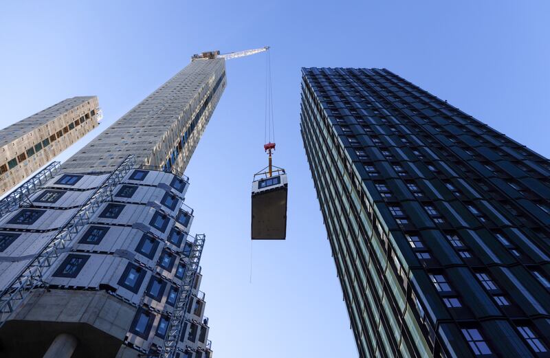 A crane lifts a section of apartment being fitted into position at a construction site in Croydon, Greater London, UK. Inflation figures for Britain, due on Wednesday, are likely to hold steady before peaking in April at about 6.9 per cent. Bloomberg