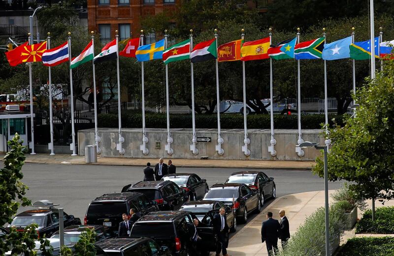 Flags fly above diplomatic vehicles on the first day of high-level meeting at United Nations headquarters.  EPA