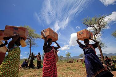 Women from the Dadinga tribe carry boxes of oil during food distribution by World Food Program (WFP) in the village of Lauro, Budy county, in Eastern Equatoria State, south Sudan, 3 April, 2010. Goran Tomasevic/ Reuters
