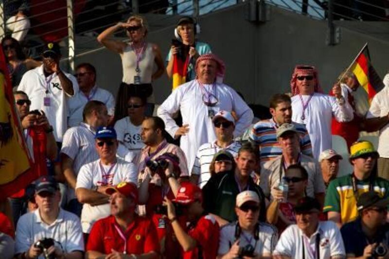 November 13, 2010 - Abu Dhabi, UAE - Fans cheer on the racers as they take to the starting grid prior to the start of the Abu Dhabi Grand Prix at Yas Marina Circuit in Abu Dhabi on Sunday November 14, 2010.  (Andrew Henderson / The National)