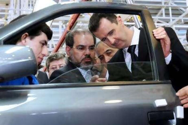 Syrian President Bashar Assad, right, inspects a car at the Syrian-Iranian Company for Manufacturing Cars in the industrial city of Adra near Damascus on Thursday, March 8, 2007. Assad inaugurated today, along with the Iranian Vice-President Parviz Davoodi, unseen, the first stage of the first Syrian-Iranian "Sham" car, the first to be produced in Syria. Some 70 cars would be put in use upon inauguration and the marketing will start at the beginning of April.(AP Photo Bassem Tellawi).