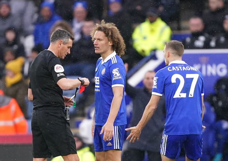 Referee Andre Marriner shows a red card to Leicester's Wout Faes. PA