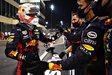 ABU DHABI, UNITED ARAB EMIRATES - DECEMBER 13: Race winner Max Verstappen of Netherlands and Red Bull Racing celebrates with his team in parc ferme during the F1 Grand Prix of Abu Dhabi at Yas Marina Circuit on December 13, 2020 in Abu Dhabi, United Arab Emirates. (Photo by Mark Thompson/Getty Images)