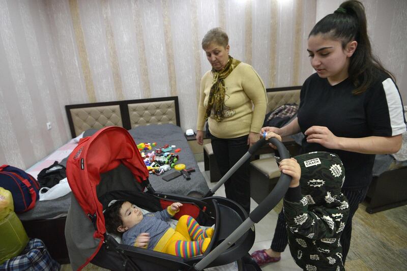 Marine Sargasyan, left, her stepdaughter Anzhelika Astribabayan and her grandchildren children take refuge in a hotel room in Nagorno-Karabakh's main city of Stepanakert after fleeing the nearby town of Shusha. AFP