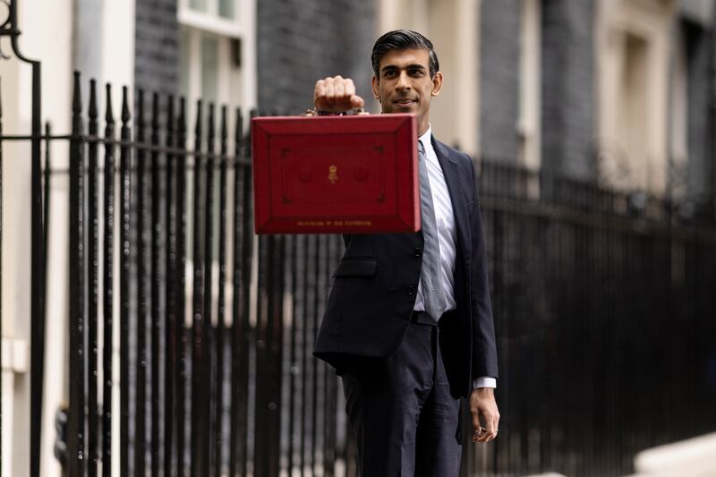 Holding the budget box as he departs 11 Downing Street to deliver his Autumn Budget in October 2021. Getty Images