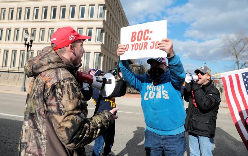 A U.S. President-elect Joe Biden's supporter argues with two U.S. President Donald Trump's supporters as the Board of State Canvassers meet to certify the results of the election in Lansing, Michigan. Reuters