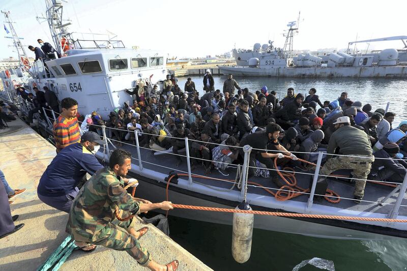 Illegal migrants of different African nationalities arrive at a naval base in the capital Tripoli on April 22, 2018, after they were rescued off the coast of Zlitan from two inflatable boats. - At least eleven migrants died at sea and another 263 were rescued in two separate operations off the coast of Libya, the country's navy said. (Photo by MAHMUD TURKIA / AFP)