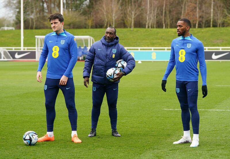 New England coach Jimmy Floyd Hasselbaink, centre, alongside Harry Maguire, left, and Ivan Toney. PA