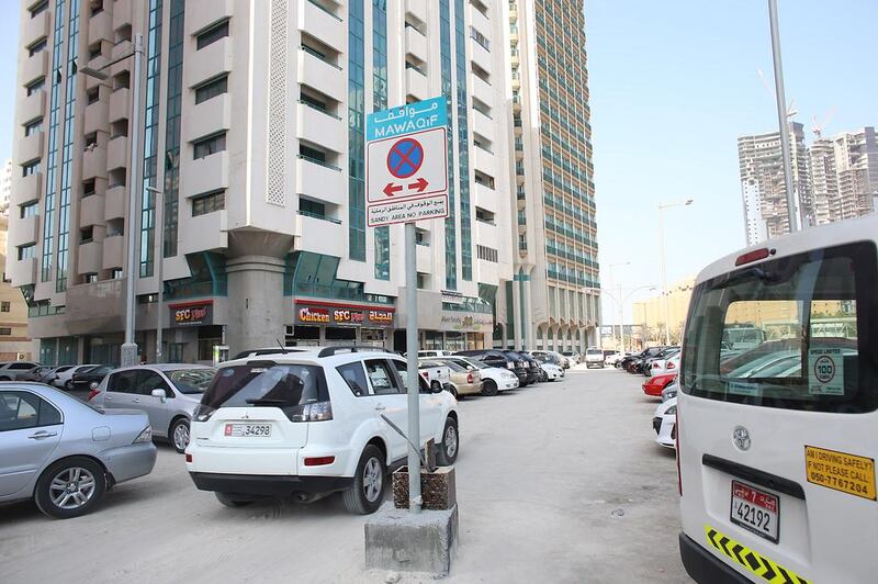 BEFORE: Illegally parked cars near the Porsche showroom on Salam Street. Delores Johnson / The National 