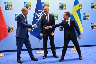 Turkish President Recep Tayyip Erdogan and Swedish Prime Minister Ulf Kristersson shake hands next to Nato Secretary-General Jens Stoltenberg before their meeting. AP