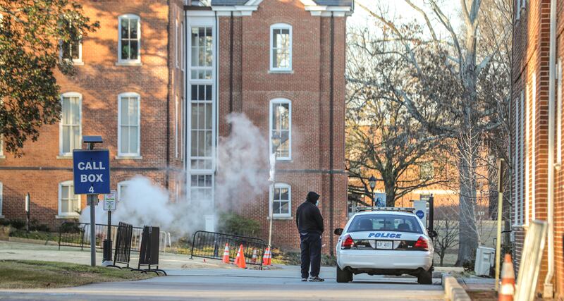 A man speaks with a police officer in a patrol vehicle outside the Spelman campus after two historically black colleges in Georgia received bomb threats on Tuesday morning. AP