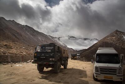 In this Sept. 14, 2018, photo, an Indian Army truck crosses Chang la pass near Pangong Lake in Ladakh region, India. Indian and Chinese soldiers are in a bitter standoff in the remote and picturesque Ladakh region, with the two countries amassing soldiers and machinery near the tense frontier, Indian officials said. The standoff began in early May, 2020, when large contingents of Chinese soldiers entered deep inside Indian-controlled territory at three places in Ladakh, erecting tents and posts, the officials said this week. They said the soldiers ignored repeated verbal warnings, triggering a yelling match, stone-throwing and even fist fights in at least one place along Pangong Lake, the site of several such confrontations in the past. (AP Photo/Manish Swarup)