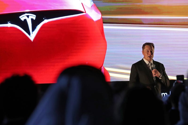 Elon Musk, the co-founder and chief executive Tesla, gives a presentation about the company at the World Government Summit on Monday. Karim Sahib / AFP