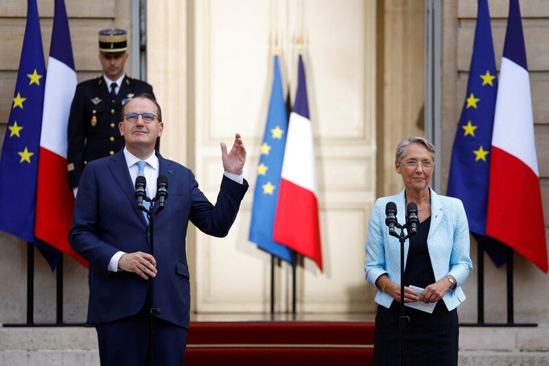 Mr Castex gestures next to Ms Borne. Reuters