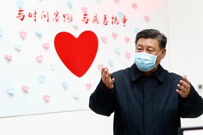 In this Feb. 10, 2020, photo released by Xinhua News Agency, Chinese President Xi Jinping gestures near a heart shape sign and the slogan "Race against time, Fight the Virus" during an inspection of the center for disease control and prevention of Chaoyang District in Beijing. Xi said on Wednesday, Feb. 12, 2020, that he is promising tax cuts and other aid to industries hurt by a virus outbreak in a renewed effort to rein in the rising damage to the economy. (Liu Bin/Xinhua via AP, File)