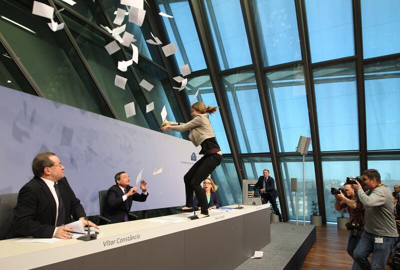 Mario Draghi looks aghast as the protester approaches him. Daniel Roland / AFP