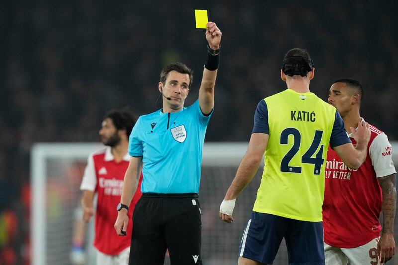 Zurich's Nikola Katic is shown a yellow card by referee Erik Lambrechts. AP