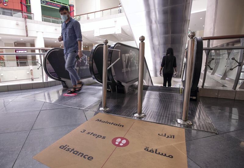 Abu Dhabi, United Arab Emirates, May 10, 2020.  
 The reopening of the Al Wahda Mall during the Coronavirus pandemic.  A safe distance sign on the escalator.
Victor Besa/The National
Section:  NA
Reporter:
