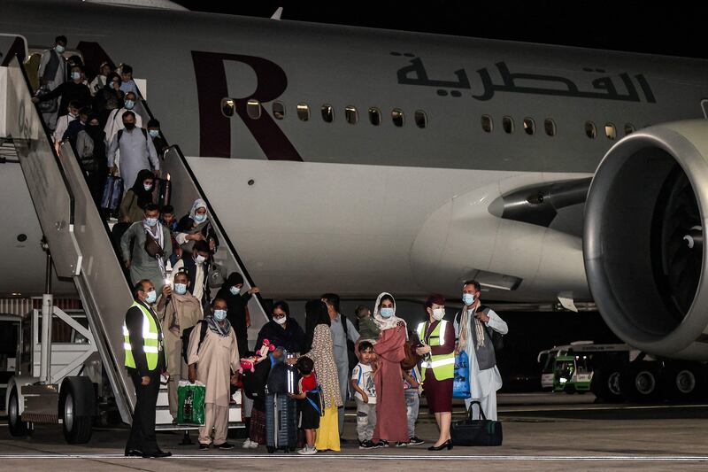 Evacuees from Afghanistan arrive at Hamad International Airport in Qatar's capital Doha on the first flight carrying foreigners out of the Afghan capital since the US withdrawal last month. AFP