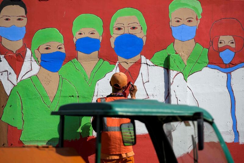 A city worker draws a mural campaigning against the Covid-19 on a wall in Jakarta.  Indonesia had reported over 150,000 coronavirus cases and 6,858 deaths, but with some of the world's lowest testing rates the true scale is widely believed to be much greater.  AFP