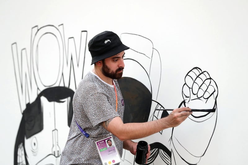 Dubai, United Arab Emirates - October 20, 2019: Rami Al Afifi creates art at the One year to go celebrations. Sunday the 20th of October 2019. Burj Park, Dubai. Chris Whiteoak / The National