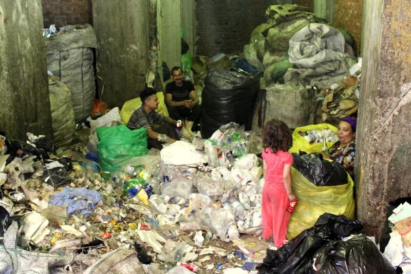 A Coptic Christian family sorts through rubbish in the Cairo slum of Manshiyat Naser. Sandor Jaszberenyi for The National / May 14, 2014
