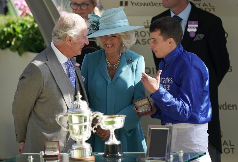 Prince Charles, the Prince of Wales, and Camilla, the Duchess of Cornwall, present The St James's Palace Stakes trophy to jockey William Buick after his victory on Coroebus at Royal Ascot. PA