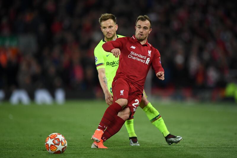 LIVERPOOL, ENGLAND - MAY 07:  Xherdan Shaqiri of Liverpool is watched by Ivan Rakitic of Barcelona during the UEFA Champions League Semi Final second leg match between Liverpool and Barcelona at Anfield on May 07, 2019 in Liverpool, England. (Photo by Shaun Botterill/Getty Images)
