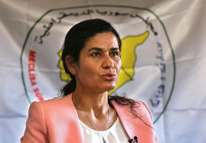 FILE - In this July 25, 2017 file photo, Ilham Ahmed, the co-president of the Syrian Democratic Council, the political wing of the Kurdish-led forces backed by the US in Raqqa, gives an interview to The Associated Press, in Kobani, north Syria. Ahmed, in Washington on Tuesday, Jan. 29, 2019, said the United States is seeking to broker an agreement between her group and Turkey over how to manage northeastern Syria once American troops withdraw. Ahmed was in Washington to lobby for a negotiated U.S. troop withdrawal that would secure her forces' continued presence. (AP Photo/Hussein Malla, File)