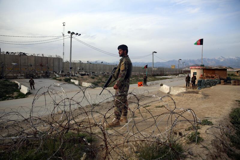 Afghan National Army soldiers stands guard at a checkpoint near the Bagram base in northern Kabul, Afghanistan, Wednesday, April 8, 2020. An Afghan official says the country has released 100 Taliban prisoners from Bagram, claiming they are part of 5,000 detainees who are to be freed under a deal between insurgents and U.S. But the Taliban says they have yet to verify those released were on the list they had handed over to Washington during negotiations. (AP Photo/Rahmat Gul)