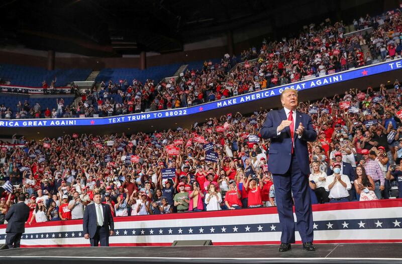 FILE PHOTO: U.S. President Donald Trump reacts to the crowd as he arrives onstage at his first re-election campaign rally in several months in the midst of the coronavirus disease (COVID-19) outbreak, at the BOK Center in Tulsa, Oklahoma, U.S., June 20, 2020. REUTERS/Leah Millis/File Photo