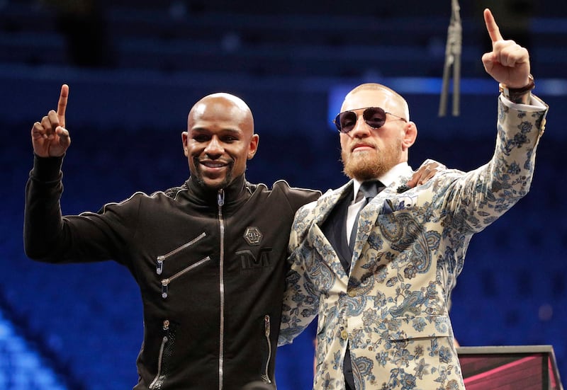 Floyd Mayweather Jr., left, and Conor McGregor pose during a news conference after a super welterweight boxing match Sunday, Aug. 27, 2017, in Las Vegas. (AP Photo/Isaac Brekken)