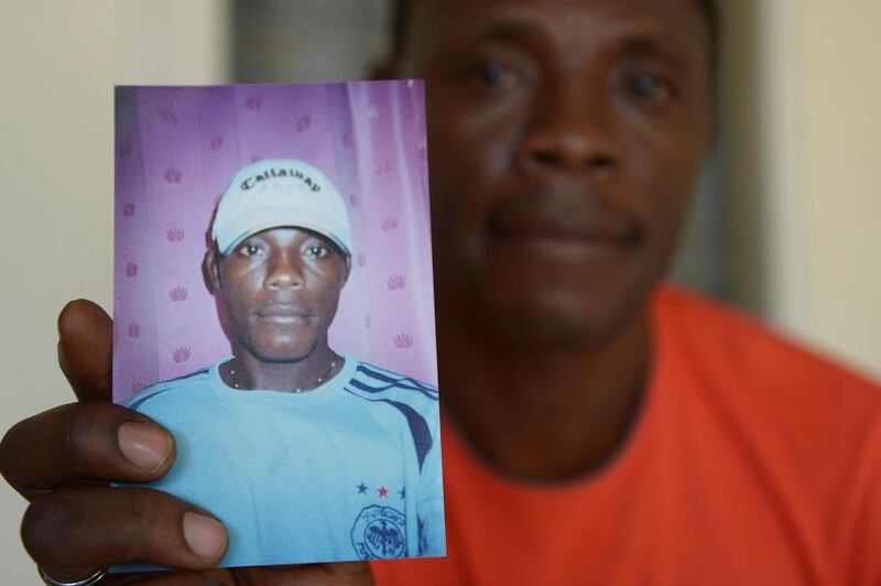 Beliby Ferdinand Bengondo holding a picture of his late brother, Salomon Bengondo.  Cameroonian striker Salomon Bengondo arrived in Indonesia in 2005, a promising young footballer who hoped to build a career in Southeast Asia's biggest nation. But instead of sporting glory, his story ended in tragedy. Adek Berry / AFP