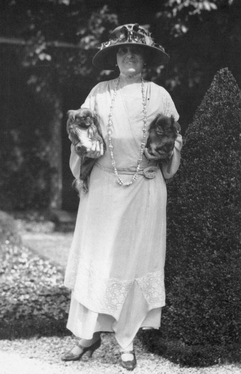 The American writer Edith Wharton photographed at home in France with her two pet dogs, sometime in the 1920s. Wharton was a devoted Francophile who surrounded herself with sometimes garish or sentimental French designs. Granger / REX / Shutterstock