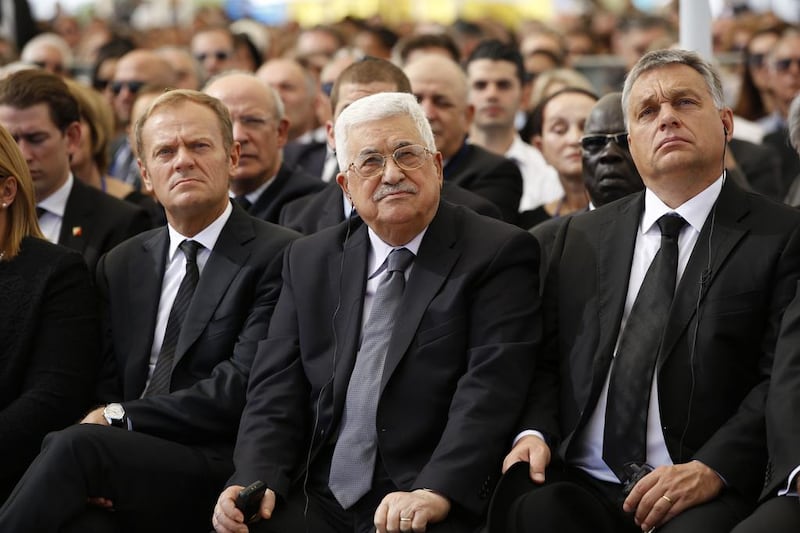 Palestinian president Mahmoud Abbas, centre, sits next to European Council president Donald Tusk, left, during the funeral of Shimon Peres in Jerusalem on September 30, 2016. Abir Sultan / Associated Press