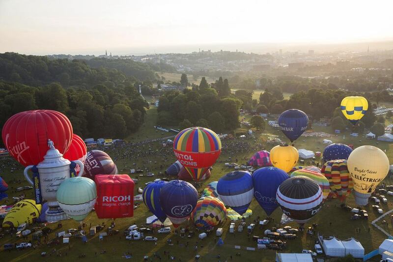 Over 120 hot air balloons depart.