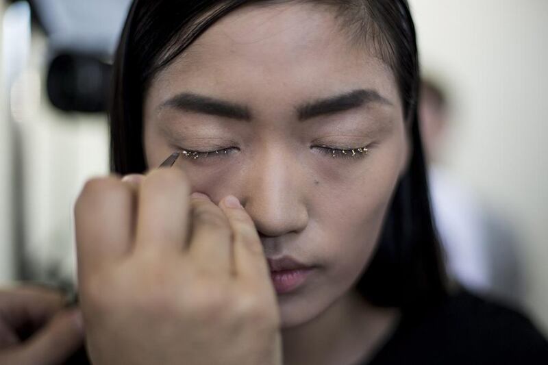 Qiwen Feng has her makeup done backstage prior to the presentation of the Dries Van Noten collection during the Spring/Summer 2014 Ready to Wear Paris Fashion Week. Yoan Valat / EPA