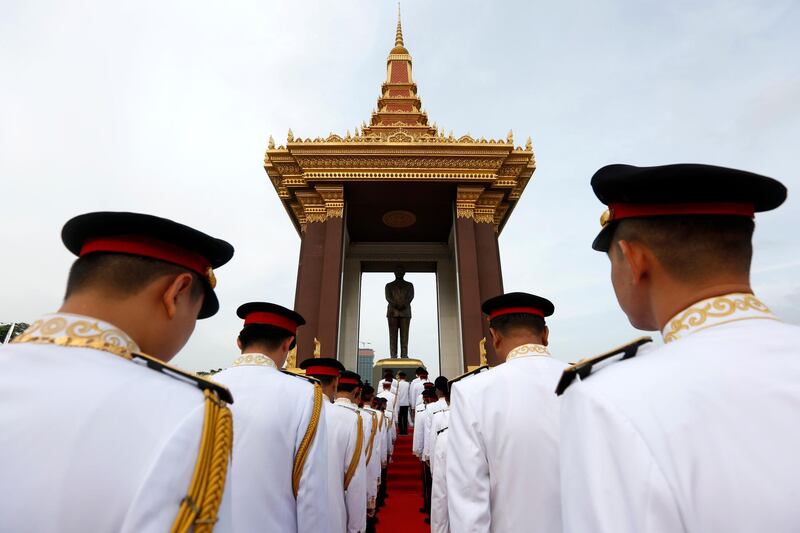 Officials attend a wreath-laying ceremony at the statue of the late King Norodom Sihanouk in Phnom Penh, Cambodia, EPA