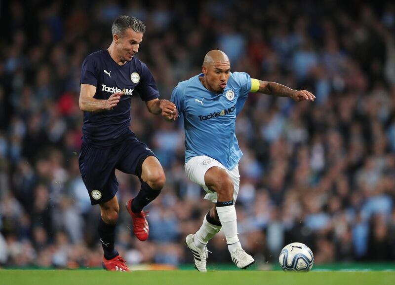 Manchester City Legends' Nigel de Jong in action with Premier League All-Stars' Robin Van Persie. Reuters