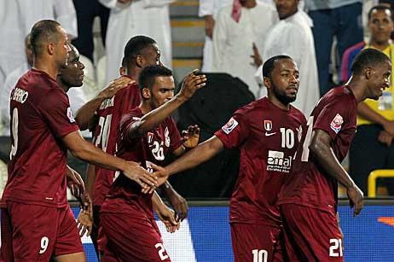 Al Wahda players show their relief after beating Hekari in the opening match of the Club World Cup.