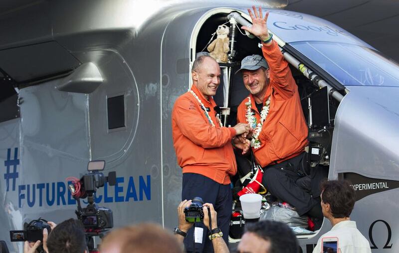 Bertrand Piccard, left, congratulates Solar Impulse 2 co-pilot Andre Borschberg after the latter’s five-day record-breaking flight from Japan to Hawaii.  Eugene Tanner / AFP