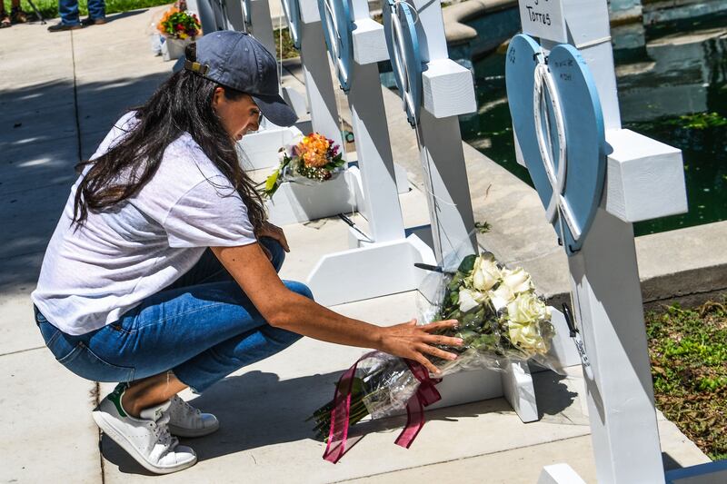 Meghan, Duchess of Sussex, places flowers at a makeshift memorial outside Uvalde County Courthouse in Uvalde, Texas. AFP