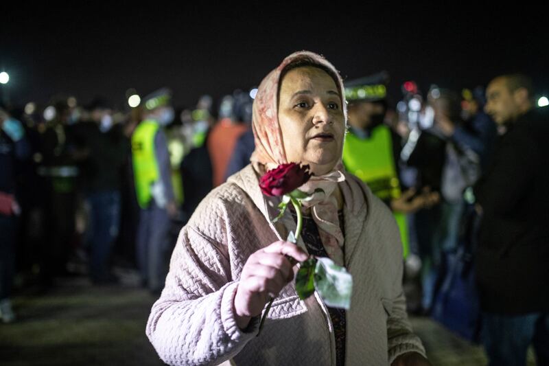 The mother of a Moroccan student who was studying in Ukraine holds a flower to give her as she arrives at Casablanca airport in Morocco. AP Photo
