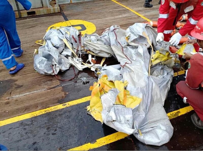 Rescuers inspect debris believed to be from the Lion Air passenger jet. AP Photo