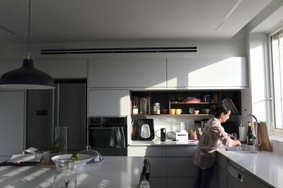 Roni Weingarten, an architect, stands in her kitchen in Oranit settlement. Rose Scammell for The National